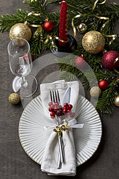 Christmas place setting with fork and knife, glass, ribbon and christmas decorations