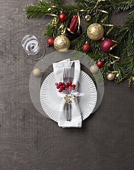 Christmas place setting with fork and knife, glass, ribbon and christmas decorations