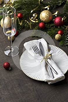 Christmas place setting with fork and knife, ribbon and christmas decorations