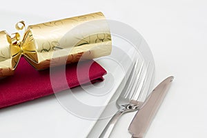 Christmas place setting with gold cracker