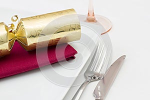 Christmas place setting with gold cracker