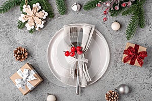 Christmas place setting on gray table.