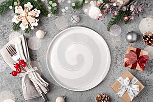 Christmas place setting on gray table.