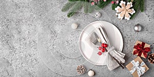 Christmas place setting on gray table.