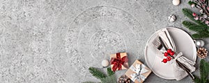 Christmas place setting on gray table.