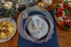 Christmas place setting and greenery on a table