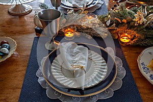 Christmas place setting and greenery on a table