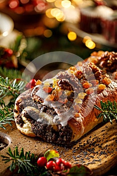 Christmas poppy seed cake,covered with icing and decorated with raisins and walnuts on the holiday table.