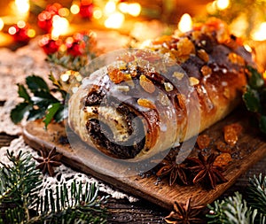 Christmas poppy seed cake, traditional baking in a festive arrangement with flickering lights