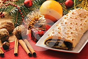 Christmas poppy seed roll on festive table.