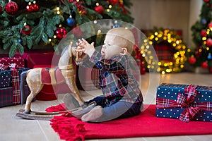 Christmas portrait of cute little newborn baby boy, dressed in christmas clothes and wearing santa hat, studio shot, winter time