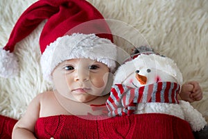 Christmas portrait of cute little newborn baby boy, wearing santa hat