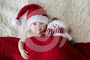 Christmas portrait of cute little newborn baby boy, wearing santa hat