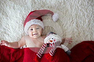 Christmas portrait of cute little newborn baby boy, wearing santa hat