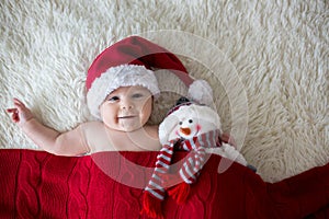 Christmas portrait of cute little newborn baby boy, wearing santa hat