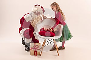 Christmas portrait of cute little newborn baby girl, dressed in christmas clothes, studio shot, winter time