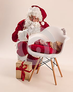 Christmas portrait of cute little newborn baby girl, dressed in christmas clothes, studio shot, winter time