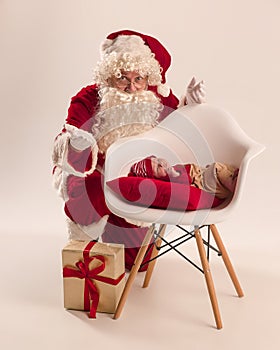 Christmas portrait of cute little newborn baby girl, dressed in christmas clothes, studio shot, winter time