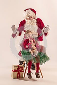 Christmas portrait of cute little newborn baby girl, dressed in christmas clothes, studio shot, winter time