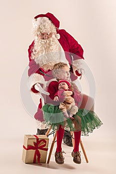 Christmas portrait of cute little newborn baby girl, dressed in christmas clothes, studio shot, winter time