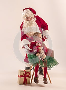 Christmas portrait of cute little newborn baby girl, dressed in christmas clothes, studio shot, winter time