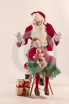 Christmas portrait of cute little newborn baby girl, dressed in christmas clothes, studio shot, winter time