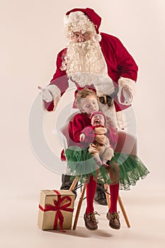 Christmas portrait of cute little newborn baby girl, dressed in christmas clothes, studio shot, winter time