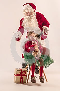 Christmas portrait of cute little newborn baby girl, dressed in christmas clothes, studio shot, winter time