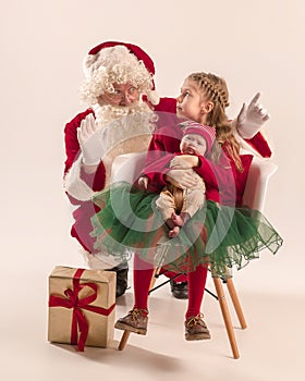 Christmas portrait of cute little newborn baby girl, dressed in christmas clothes, studio shot, winter time