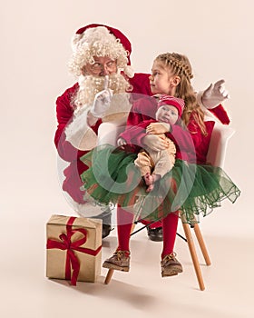 Christmas portrait of cute little newborn baby girl, dressed in christmas clothes, studio shot, winter time