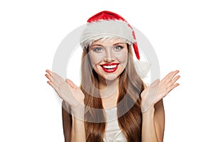 Christmas portrait of pretty surprised woman in santa claus hat isolated on white