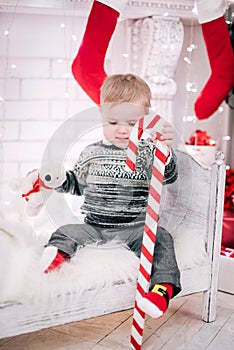 Christmas portrait of a young boy cozy atmosphere around the fireplace and Christmas tree