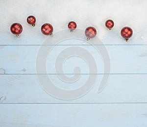 Christmas postcard with red balls and snow