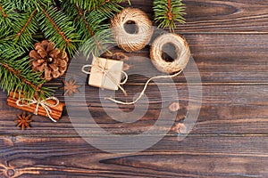 christmas present box. fir branches with cinnamon and anise on rustic wooden background. flat lay. seasonal greetings
