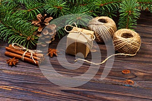 Christmas present box. fir branches with cinnamon and anise on rustic wooden background. flat lay. seasonal greetings concept. win