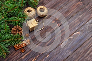 Christmas present box. fir branches with cinnamon and anise on rustic wooden background. flat lay. seasonal greetings concept. win