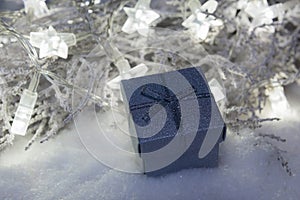 Christmas present box in snow with star lights