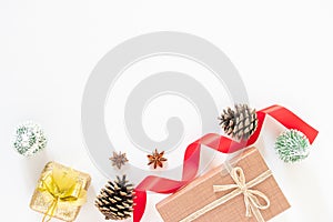 Christmas present brown gifts box and decorating elements on white background. Flat lay, top view and copy space. Christmas