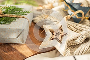 Christmas present decorated with branch in boho rustic style