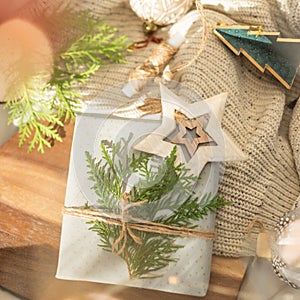 Christmas present decorated with branch in boho rustic style