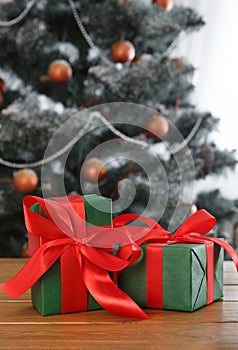 Christmas present on decorated tree background, holiday concept