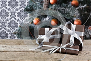 Christmas present on decorated tree background, holiday concept