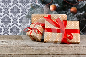 Christmas present on decorated tree background, holiday concept