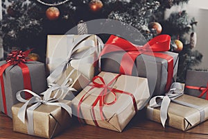 Christmas present on decorated tree background, holiday concept