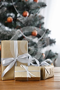 Christmas present on decorated tree background, holiday concept