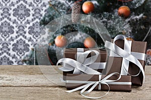 Christmas present on decorated tree background, holiday concept