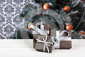 Christmas present on decorated tree background, holiday concept