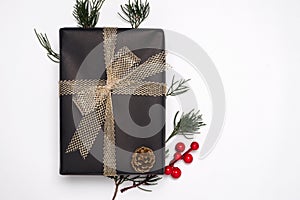 Christmas present gift boxes with decoration of fir leaves, holly berry and pine cone on white background.