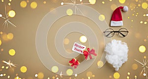 Christmas present or gift for Secret Santa with Santa hat, glasses and beard on golden celebration background