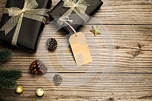 Christmas present gifts box and rustic decoration on vintage wooden background.